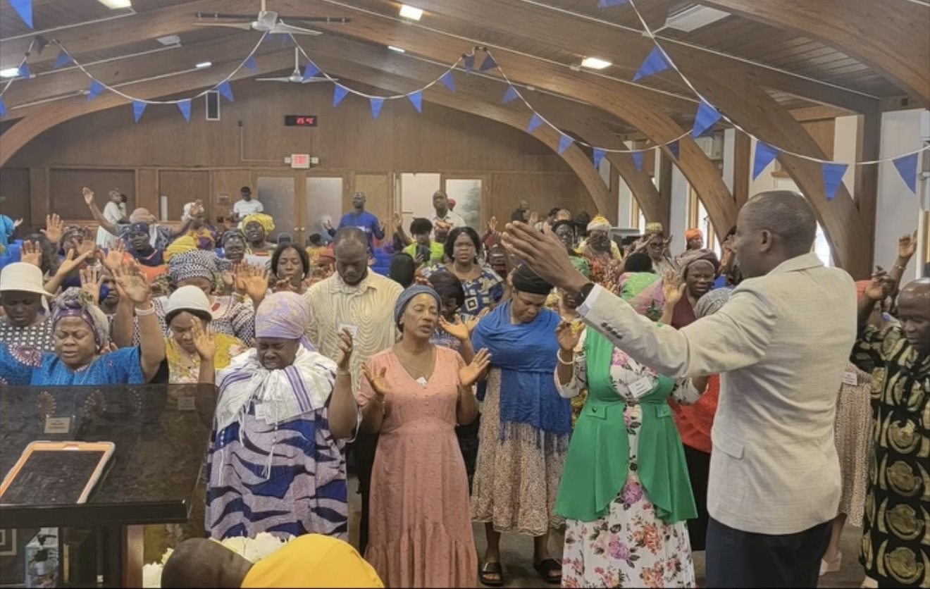 Morris Gargar leading a congregation in prayer